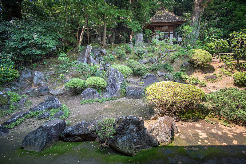 山畔を活かした地形に大小様々な石を配している